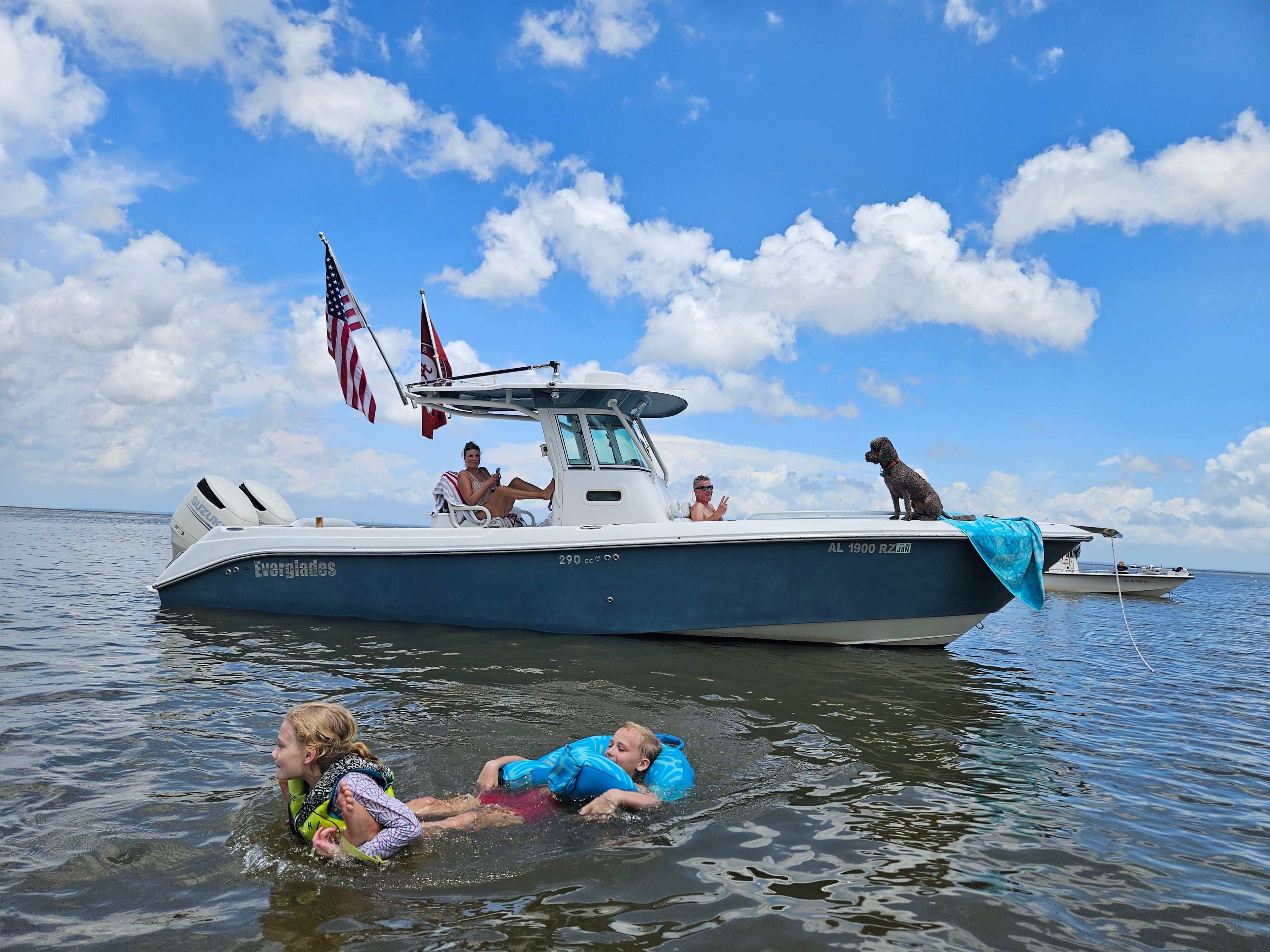 Eli swimming at Orange Beach with family and boat